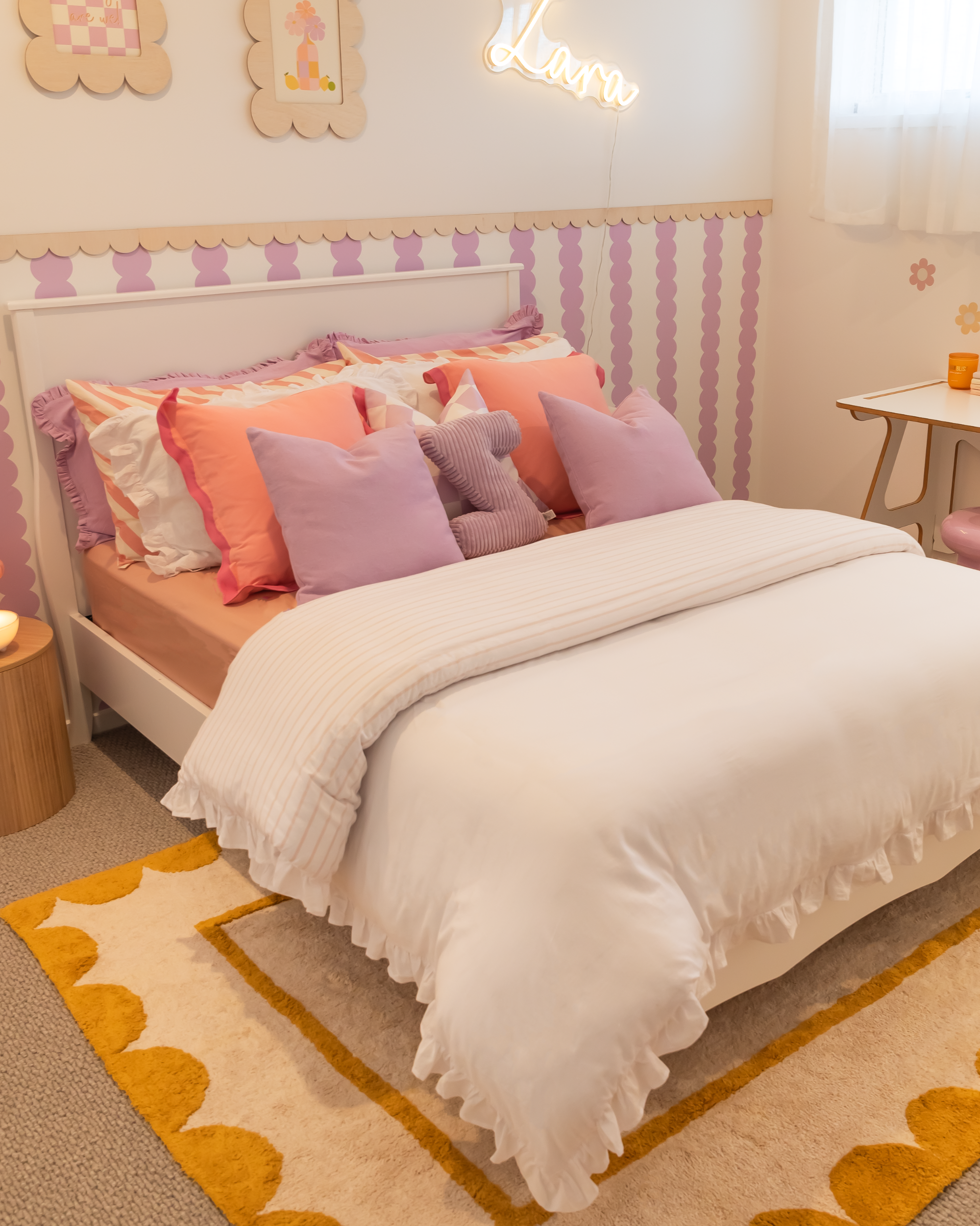 Children's bedroom with a bed, desk, and decorative elements.