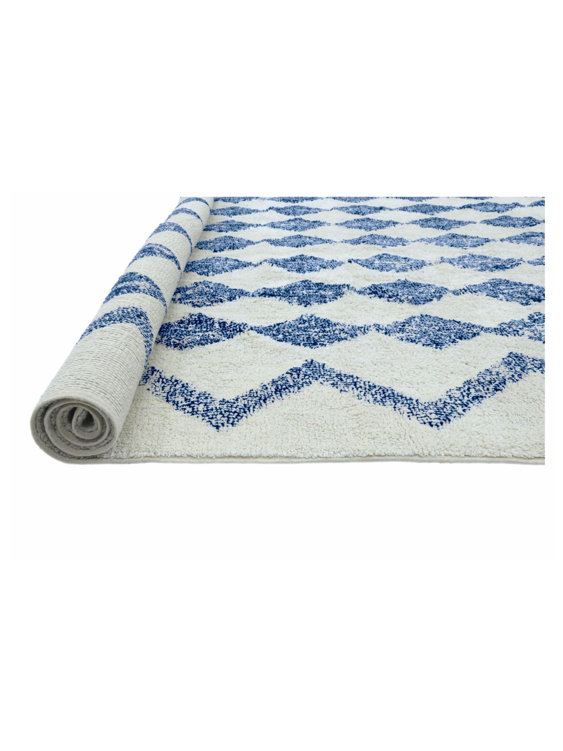 Rolled-up rug with blue and white pattern on a white background