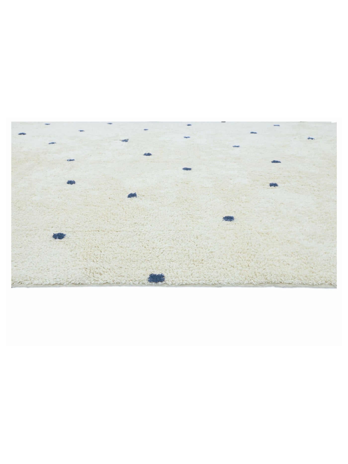 Natural rug with dusty blue polka dots on a white background